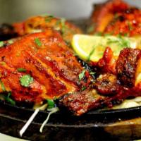 Tandoori Chicken 8 Pieces · Legs and thighs marinated in yogurt and mild spices, cooked in the tandoor. Served with rice.
