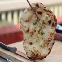 Garlic Naan · Naan baked with garlic and spices.