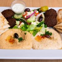 Mediterranean Sampler · A vegetarian delight with Hummus, Baba Ghanoush, Greek Salad, and Falafels. Served with Tazi...