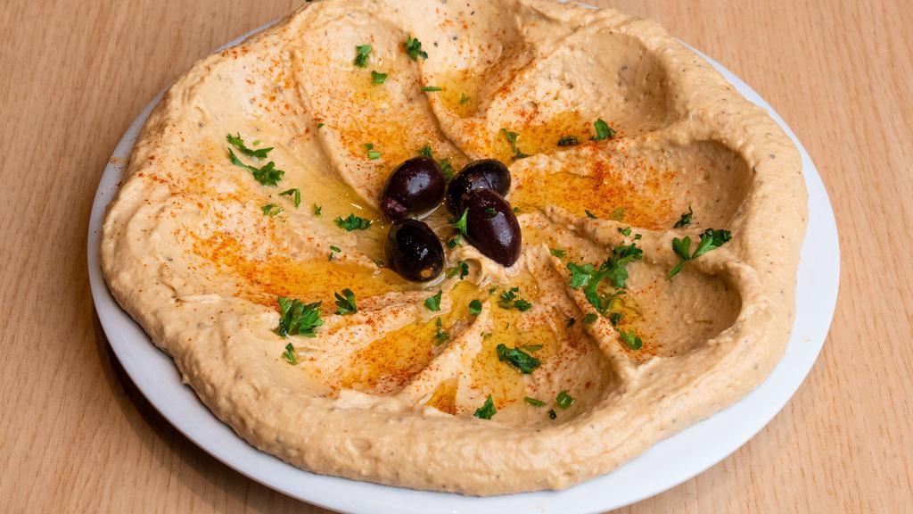 Large Hummus · House blended garbanzo beans, tahini, olive oil, fresh garlic, lemon juice, and our special seasonings. Served with 2 pita breads.