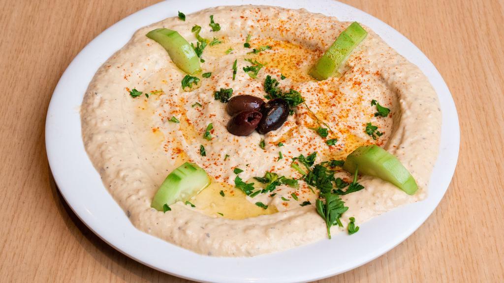 Large Baba Ghanoush · Roasted eggplant, tahini, olive oil, garlic and lemon juice all blended together. Served with a pita bread.