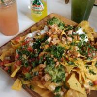 Large Loaded Nachos · Your choice of meat. Comes with Queso, pico de gallo, beans, jalapeños, guacamole and sour c...