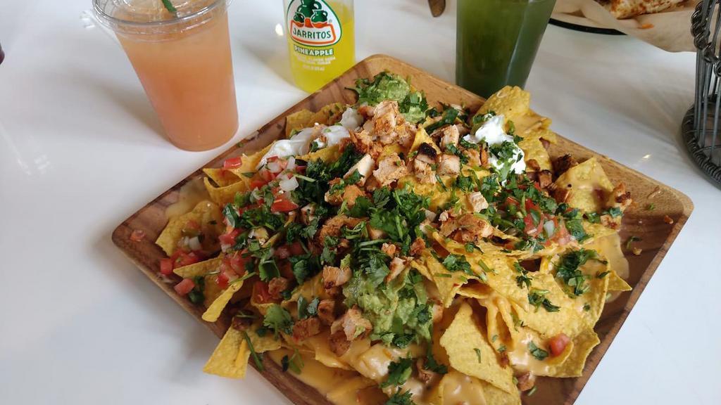 Large Loaded Nachos · Your choice of meat. Comes with Queso, pico de gallo, beans, jalapeños, guacamole and sour cream.