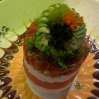 Ahi Tower · Layers of seasoned rice, crab salad, spicy tuna, ahi tuna, topped with avocado, three kinds ...