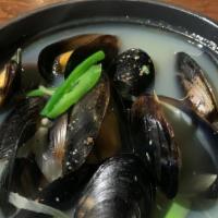 Black Mussel Pot · Black Mussels, onions, green onions in a garlicky rich soup. Has a peppery kick to it.