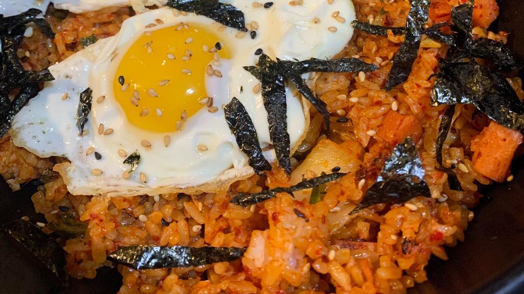 Kimchi Fried Rice · Spicy. Fresh homemade kimchi stir fried with rice, spam topped with fried egg.