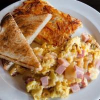 Hammer Scramble · Three eggs scrambled with smoked ham, caramelized onions & Swiss. Served with hashbrowns & t...
