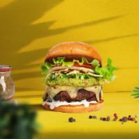 Guac Vegan Burger · Plant-based impossible patty cooked medium rare and topped with guacamole,  jalapenos, tabas...