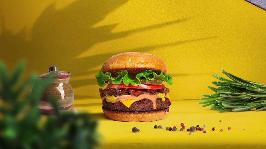 Mission Impossible Burger · Plant-based impossible meat patty topped with grilled onions, mustard, house spread, dill pickles, lettuce, and tomato.