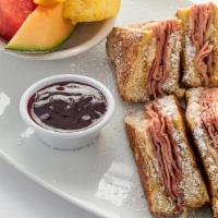 Monte Cristo · Grilled ham and Swiss cheese on thick French toast. Served with raspberry sauce and your cho...