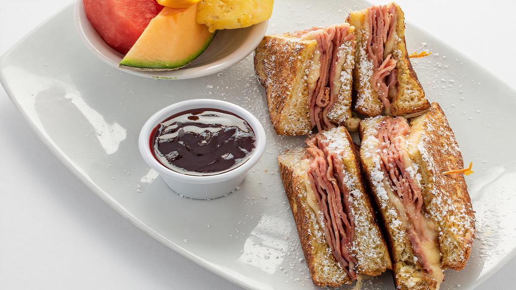 Monte Cristo · Grilled ham and Swiss cheese on thick French toast. Served with raspberry sauce and your choice of side. Per person.