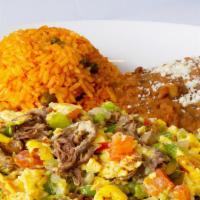 Machaca · Two eggs scrambled with shredded beef, onion, bell peppers, and tomato. Served with Mexican ...