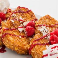 Crunchy French Toast · Vegetarian. Three slices of bread with crunchy Frosted Flakes, sliced almonds, raspberries, ...