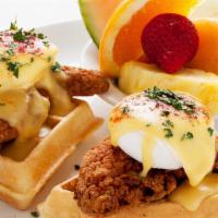 Chicken & Waffle Benedict · Two Belgian waffle quarters topped with crispy chicken tenders, poached eggs, and hollandais...