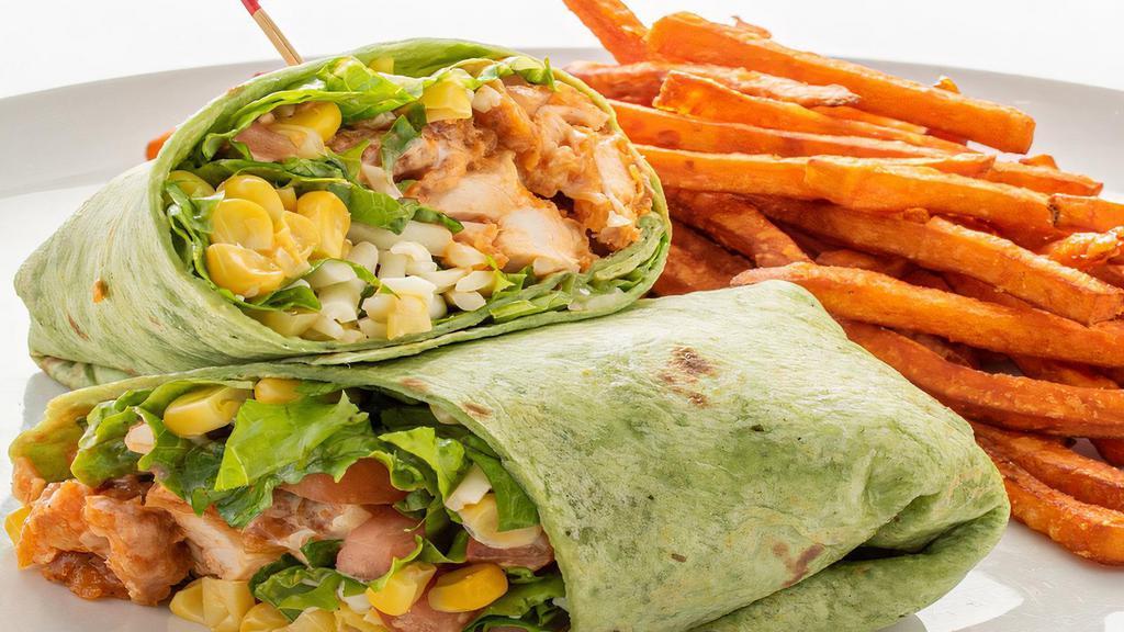 Buffalo Chicken Wrap · Spicy. Crispy Buffalo chicken strips, lettuce, tomatoes, Jack cheese, corn, and ranch dressing in a spinach tortilla. Served with your choice of side. Per person.