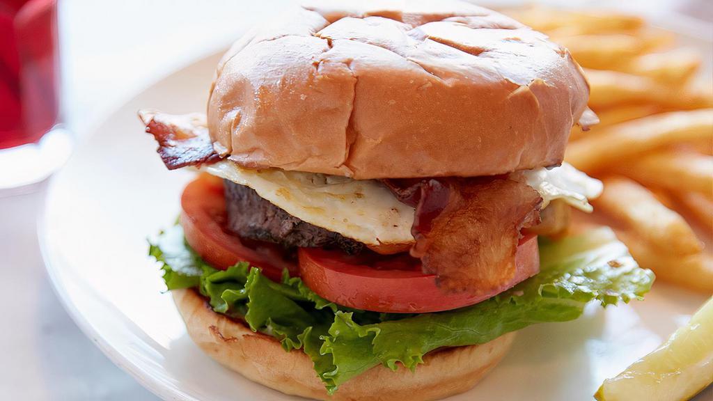 Good Morning Burger · Half-pound Angus beef patty, bacon, cheddar, two fried eggs, lettuce, tomatoes, and mayonnaise on a grilled brioche bun. Served with your choice of side. Per person.