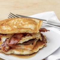 The Fatboy · Two buttermilk pancakes sandwiching eggs, cheese, and bacon strips or sausage patty.