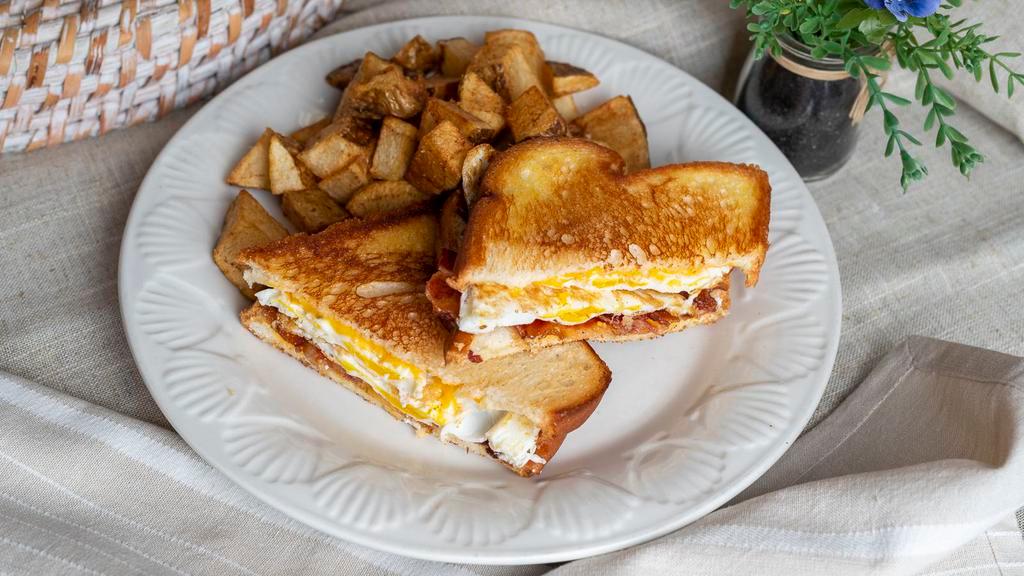 The Bacon Sandwich · Grilled white bread with gooey melted American cheese, 2 over hard eggs and crispy bacon served with home fries.