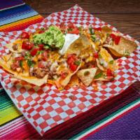 Nachos · Fresh tortilla chips covered with shredded cheese and loaded with refried beans, guacamole, ...