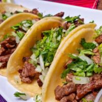 Street Tacos · 4 tacos in small corn tortillas with cilantro and onion, limes and small side of tomatillo s...