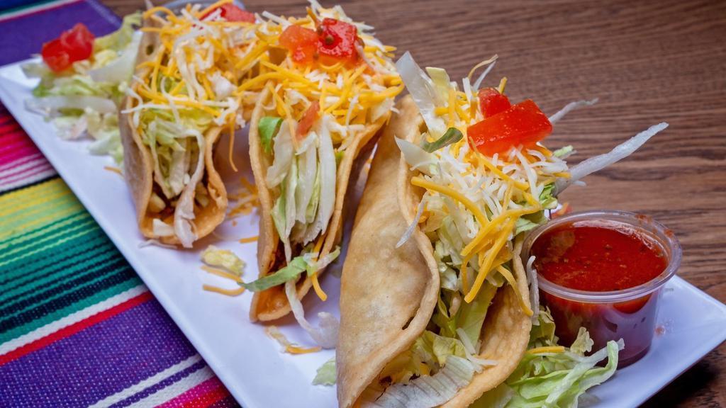 Ground Beef Tacos · Corn or flour tortillas, your choice of crispy or soft tacos, and filled with lettuce, cheese and tomatoes.