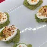 Southwest Deviled Eggs (Gf) · Chile Spiked Deviled Eggs, Smoked Avocado Sauce, Tortilla Strips, Scallions, Smoked Sea Salt.