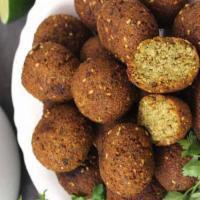 Falafels · Crispy delicious lightly fried chickpeas with pita kitchen seasoning.