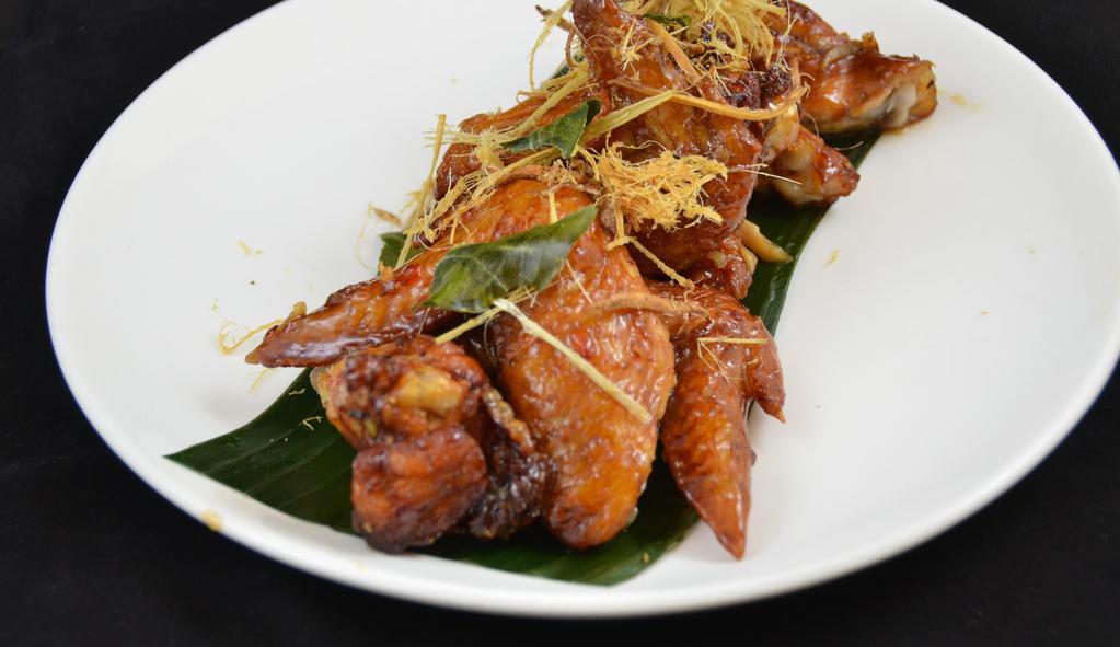 Peek Kai * · Signature wing chicken wings marinated in fish sauce, deep fried, tossed in caramelized garlic sauce.