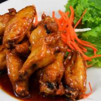 Peek Kai · Signature wing chicken wings marinated in fish sauce, deep fried, tossed in caramelized garl...