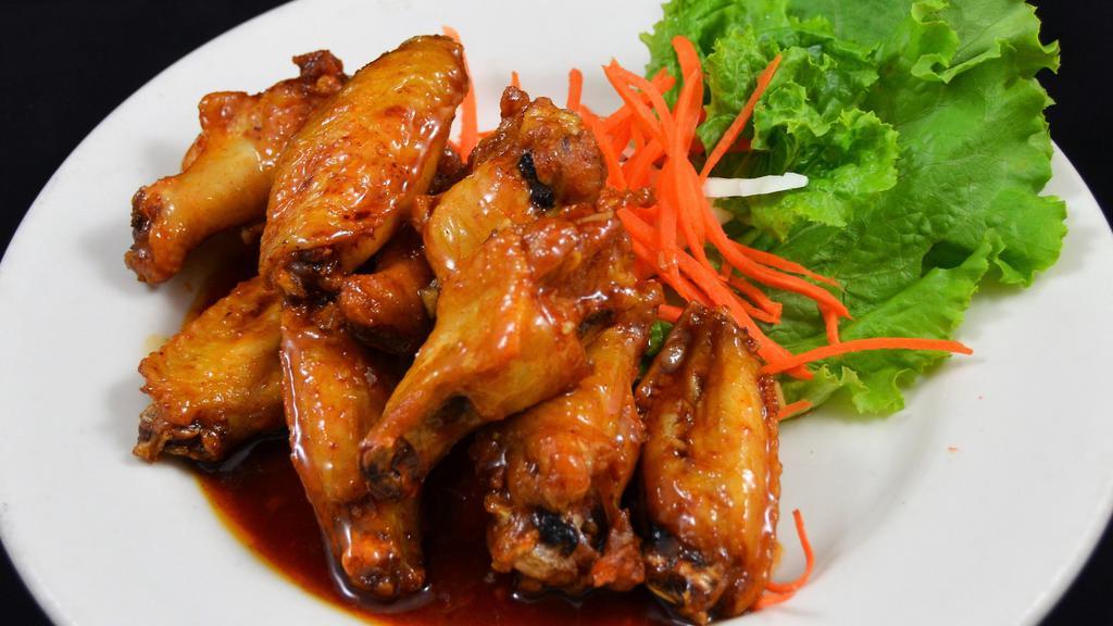 Peek Kai · Signature wing chicken wings marinated in fish sauce, deep fried, tossed in caramelized garlic sauce.