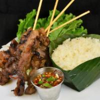Moo Ping  หมูปิ้ง · Skewers of BBQ pork shoulder marinated with sweet sesame sauce serve with northeastern style...