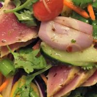 Ahi Mango Salad* · Seared Yellow fin tuna, black pepper, flavored w/ spicy lime sauce and tossed w/ lettuce, ma...