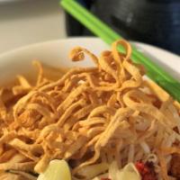 Khao Soi · Famous Northern style curry egg noodles with chicken, shallot, Thai pickled cabbage, and bea...