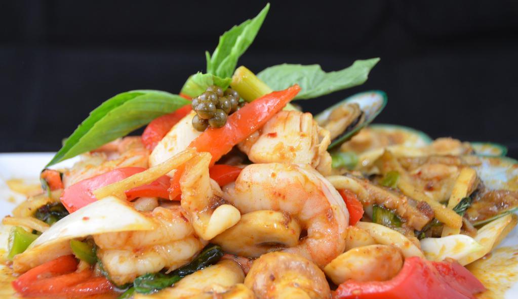 Phad Phet Talay · Stir-fried combination of seafood with homemade curry paste and Thai peppercorn, onions, bell peppers, and sweet basil.