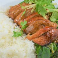 Khao Na Ped · All time favorite Thai dish honey roasted duck on a bed of jasmine rice, steamed broccoli an...
