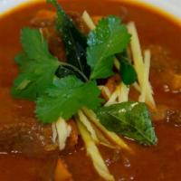 Lamb Curry · Tender bone in lamb meat slow cooked in curry sauce with specially made sauces