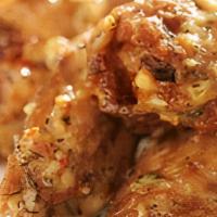 Garlic Parmesan Wings · Bone-in chicken wings fried until crispy and golden, tossed in garlic and parmesan sauce. Se...