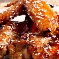 Teriyaki Wings · Bone-in chicken wings fried until crispy and golden, tossed in sweet teriyaki sauce. Served ...