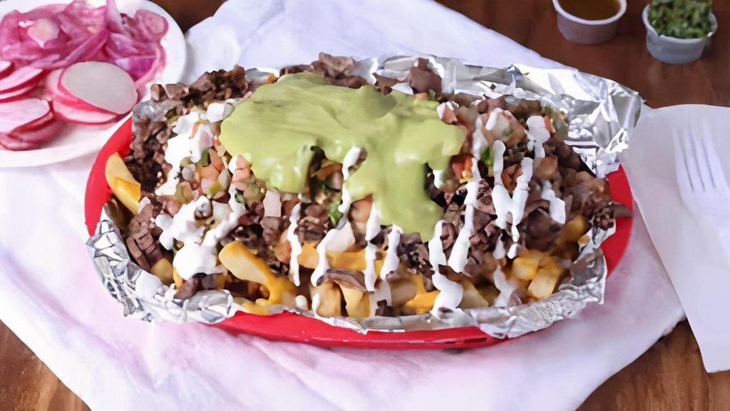 Asada Fries · Fries topped with nacho cheeses, meat, guacamole, pico de gallo and sour cream