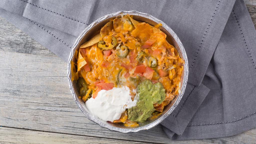 Super Nachos · Beef or chicken with bean, jalapenos, tomato, onions, cheese,sour cream and guacamole.