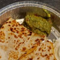 Cheese Quesadilla Appetizer · Two grilled flour tortilla filled with melted cheese, topped with sour cream and guacamole.
