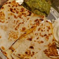 Quesadillas Appetizer · Two grilled flour tortillas filled with melted cheese and choice of chicken or beef. Garnish...