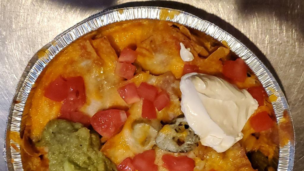 Super Nachos No Meat · With bean, jalapenos,  cheese,tomato, onions, sour cream and guacamole.