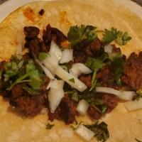 Mexican Sausage Taco · Made with a soft corn tortilla filled with cilantro and onion.