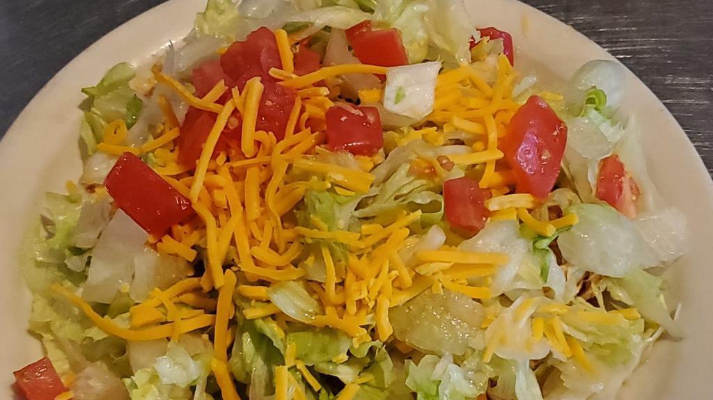 Bean Tostada · Open faced tacos with bean and toppings, shredded lettuce, cheese and tomato.