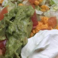 Deluxe Tostada · Bean with chicken or beef, guacamole and sour cream. Open faced tacos with bean and toppings...