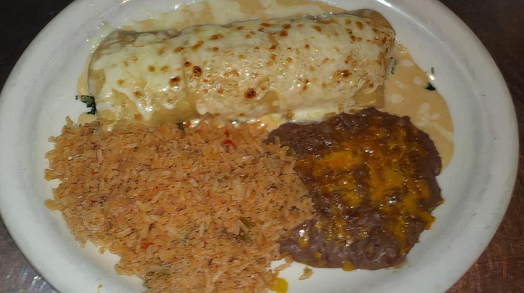 Spinach Enchiladas · Rolled corn tortilla filled with spinach, tomato and onions. Topped with a cream sauce and melted jack cheese, rice and beans.