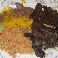 Carne Asada · Sliced of seasoned skirt steak flame broiled. Served with onions, guacamole, rice, beans and...
