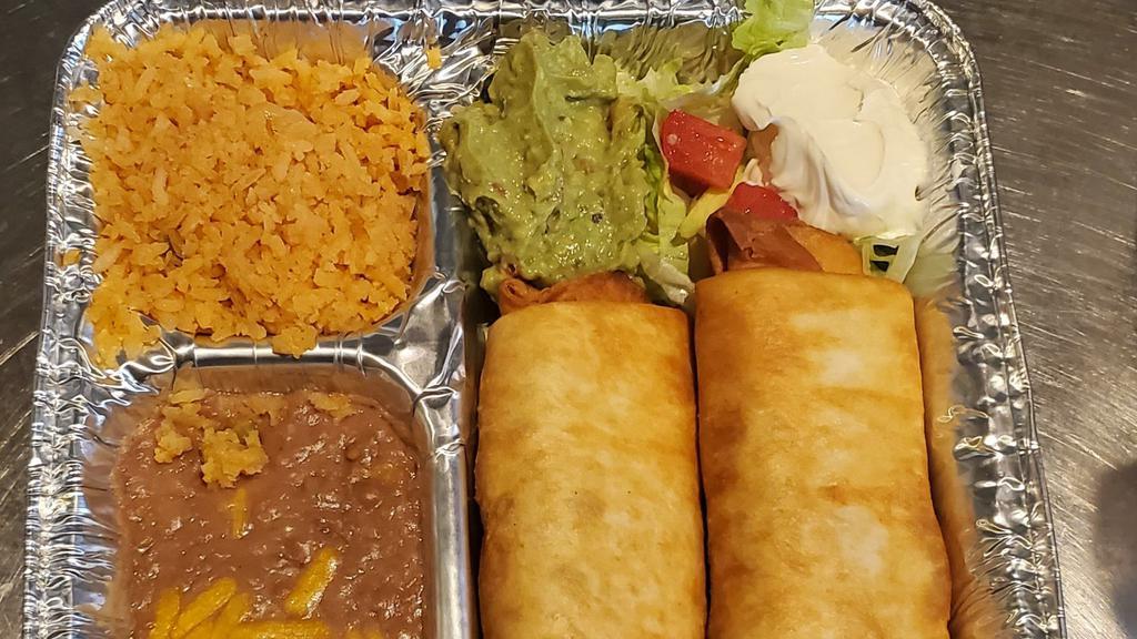 Shrimp Chimichanga · Two chimichangas stuffed with shrimp and fresh vegetables, topped with sour cream and guacamole. Served with rice and beans.
