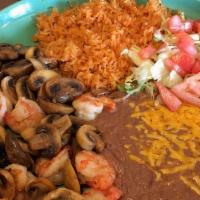 Camarones Mojo De Ajo · Shrimp sauteed in butter, garlic and mushrooms, with rice and beans.